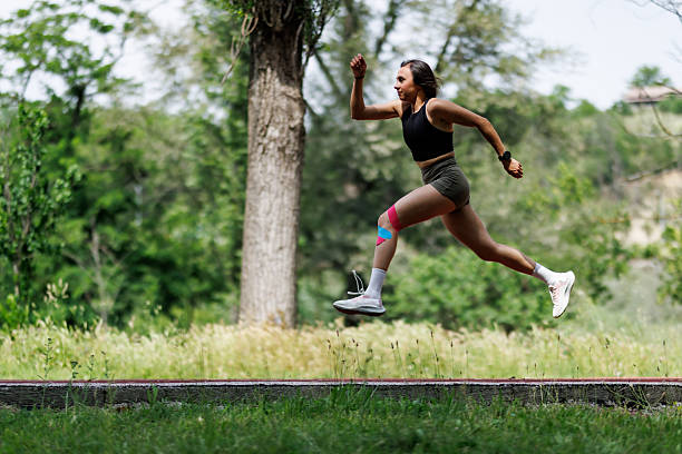 istock Athletic Woman Jumping Outdoors on a Sunny Day in a Nature Setting 2205888697