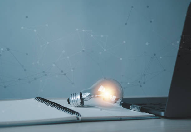 istock Light bulb and book on blue background with laptop screen. Knowledge, education, inspiration, reading, creativity, learning, idea. 2205888731