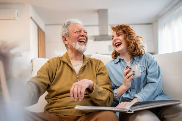 istock Father and daughter sharing a laugh while looking at photo album 2205889103