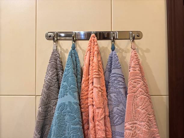 istock Five multi-colored towels on a silver steel hanger 2205891047