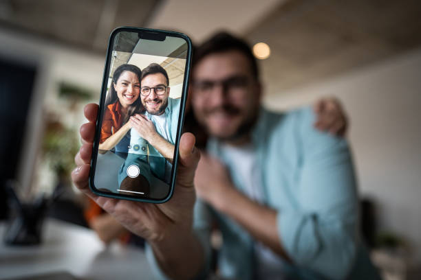 istock Young couple taking selfie with smartphone at home 2205891847