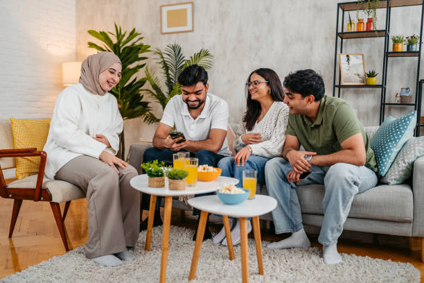 istock Group Of Indian And Muslim Friends Using A Phone Together On The Sofa 2205892012