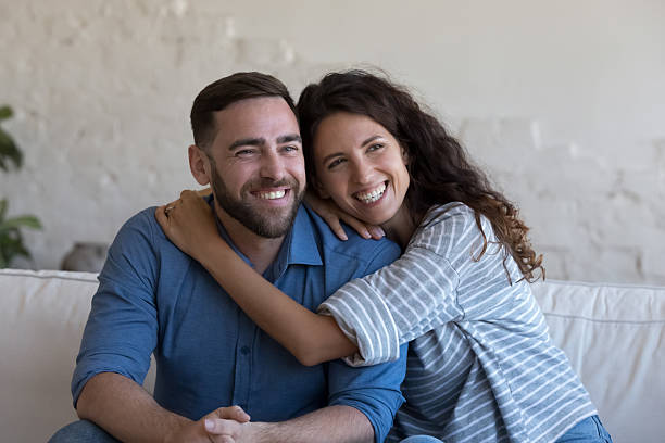 istock Cheerful attractive couple in love hugging with affection 2205892276
