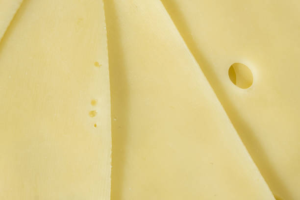 istock Semi-hard cheese close-up, thin slices, top view 2205893753