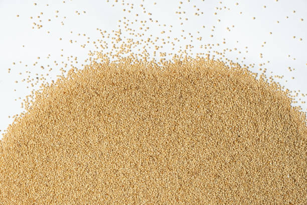 Raw organic amaranth grains on a white background, top view.