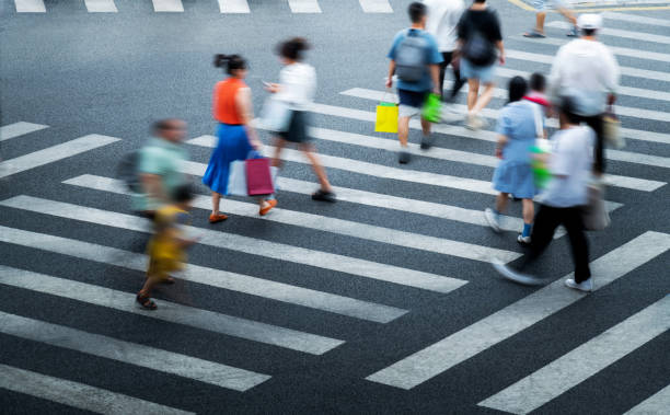 istock Crowd of people walking on crosswalk 2205894320