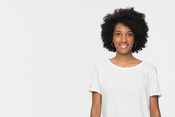 istock Smiling Woman Wearing a White Shirt in a Studio Setting 2205894480
