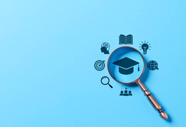 istock Online education and learning concept. Magnifying glass focus to graduation cap, surrounded by education related icon. Online learning, e-learning, knowledge discovery, digital courses, training, 2205894591