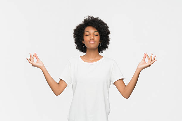 istock Calm Woman Meditating in a Minimalistic Background with Peaceful Expression 2205894704