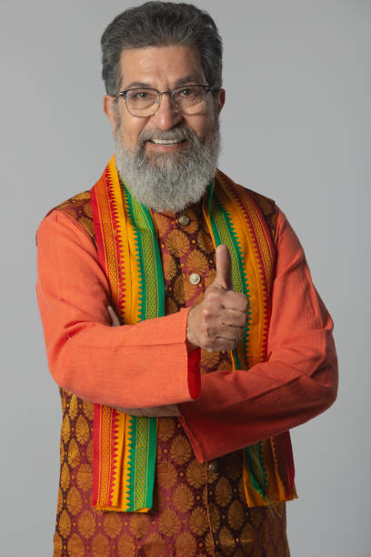 istock Old male leader showing thumbs up gesture on white background 2205895324
