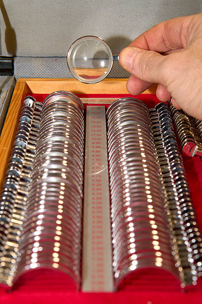 istock Optometrist holds a trial lens from a set used for eye exams and vision correction. 2205895380