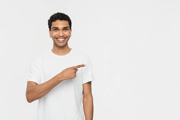 istock Smiling Young Man Pointing at Blank Space Isolated on White Background 2205895547