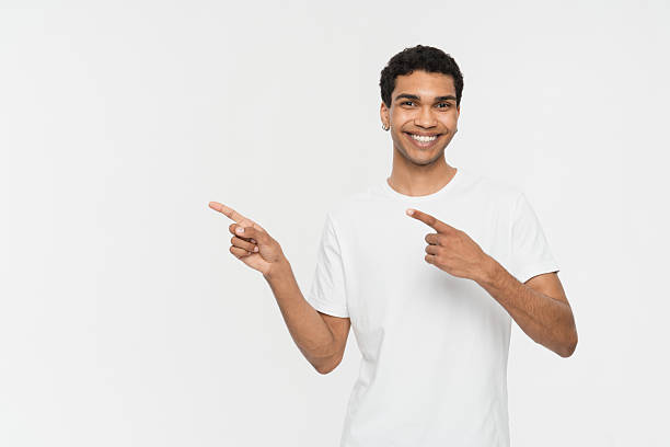 istock Smiling Man Pointing to the Side in a White Background 2205895550