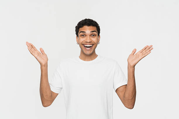istock Cheerful Man In White T-Shirt Expressing Joy with Outstretched Hands 2205895561