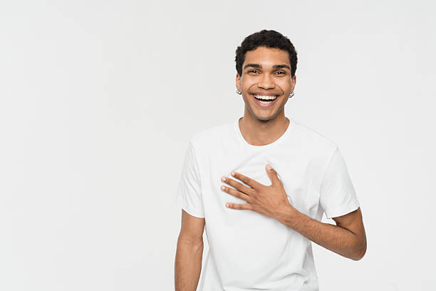 Smiling Young Man Expressing Happiness in a Clean Minimalist Studio Setting