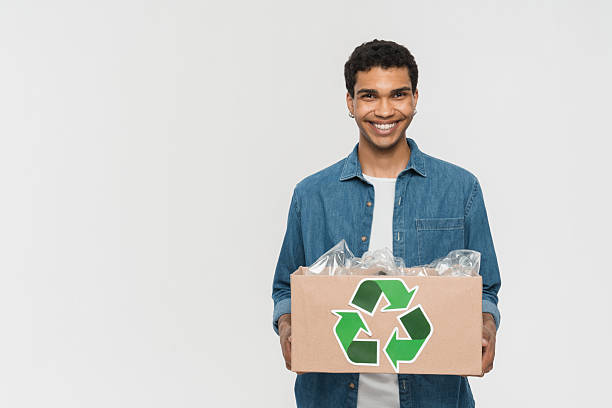 istock Smiling Man Holding Recycling Box with Eco-Friendly Packaging Materials 2205895730