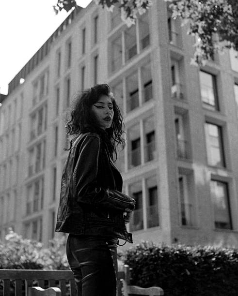 istock Female rock star standing in front of building. 2205898692