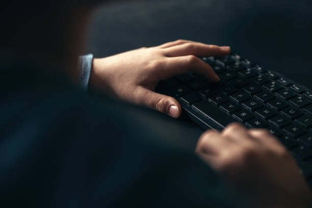 Little boy using PC, closeup of hands typing on computer keyboard, selective focus