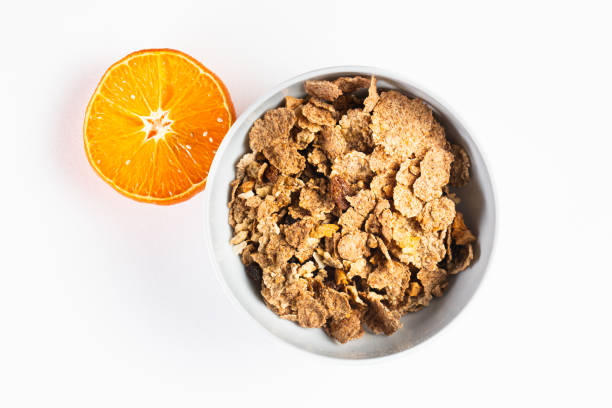 granola bowl cereal flakes orange separate on white background healthy breakfast from above
