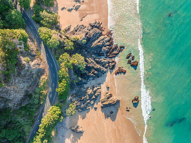 istock Winding road along rocky beach and turquoise waters. 2205900260
