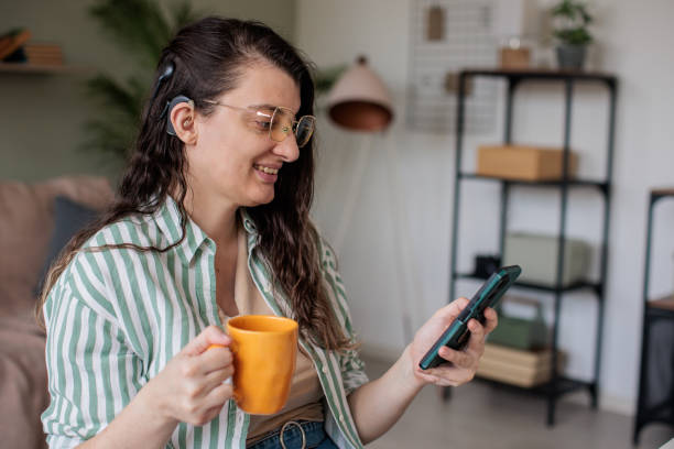 istock Woman Checking Phone While Sitting at Home 2205901950
