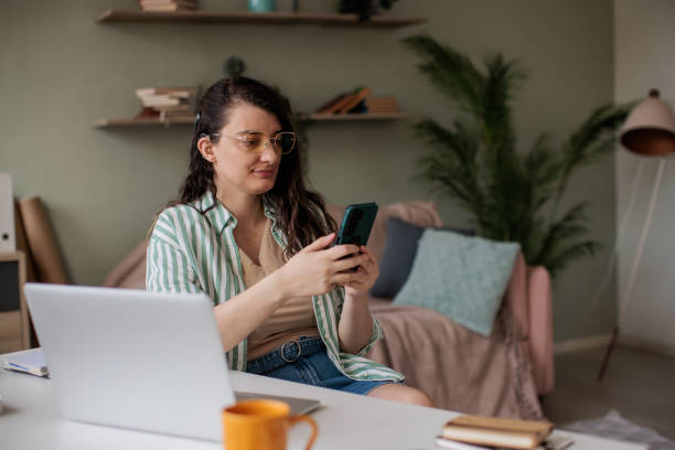 istock Woman Using Smart Phone in Home Office 2205902499
