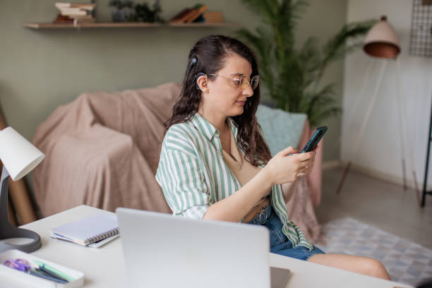 istock Woman Checking Smart Phone in Home Office 2205902531