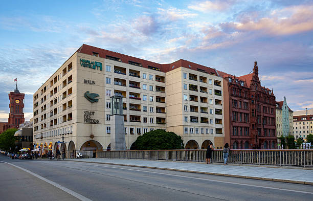 Berlin, Germany, July 6, 2024: Two women look from a bridge at the St. Nicholas quarter in Berlin in the early evening.