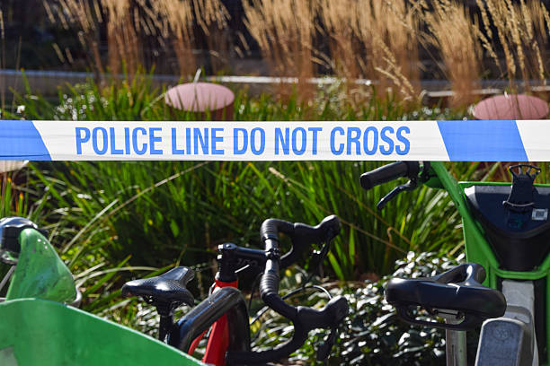 Police officer on push bike enforcing crowd control.
