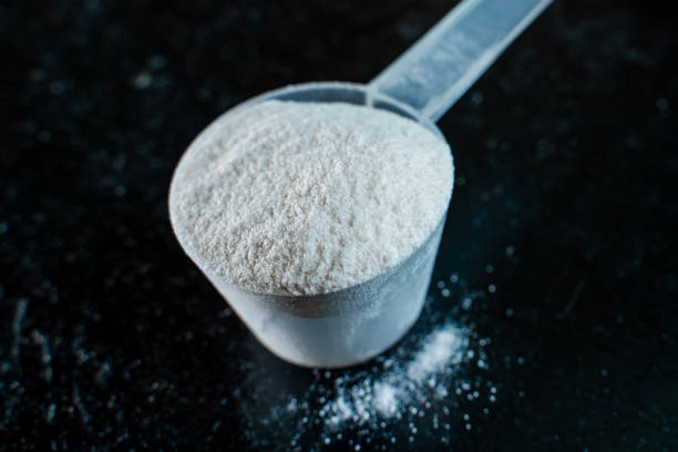 istock White powder in a scoop on a dark surface close-up 2205907348