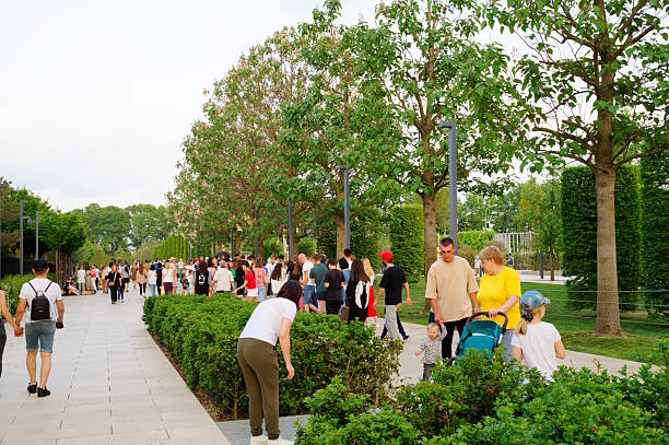 Urban park in London with visitors relaxing, jogging, and socializing, surrounded by lush greenery. London, UK, 14 April 2024