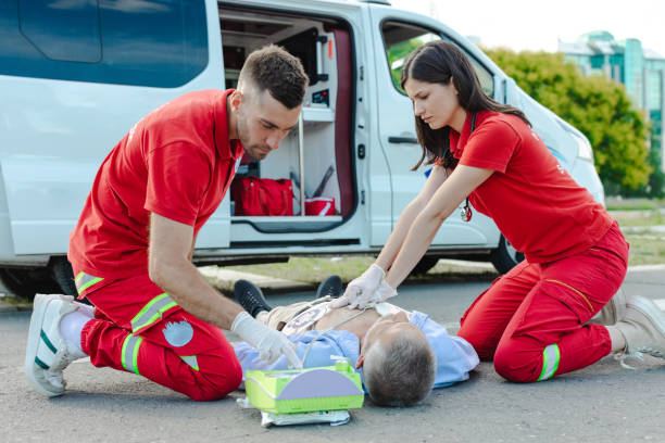 istock Emergency medical team performing CPR on a patient on a public road 2205918042