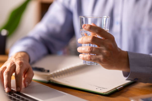 istock Businessman drinking water while working on his laptop in the office 2205919706
