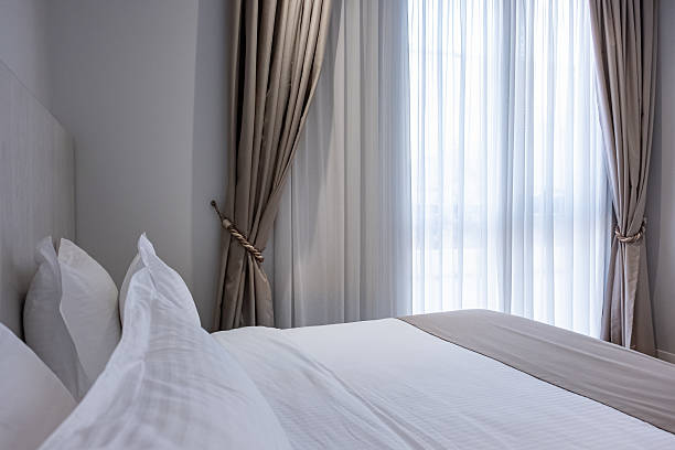 istock Modern apartment bedroom with a double bed with a headboard. Cozy bedroom interior 2205921623