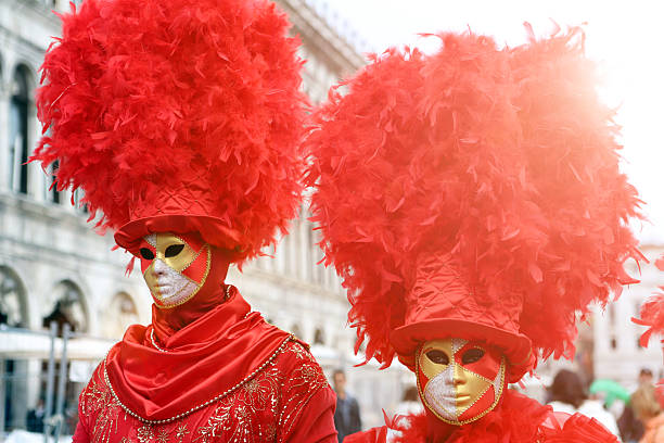 1st of March - 2025. Venice.  Italy.\n\nDuring the annual carnival - last weekend of the carnival. A couple dressed all in red poses on the St Mark Square.