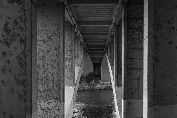 istock Underneath a bridge. Concrete bridge over the river. Low angle view of underneath highway bridge 2205921846