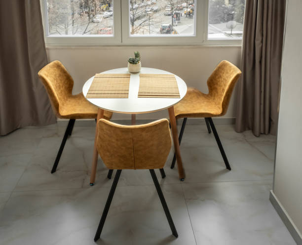 istock Dining table and three yellow chairs, modern home interior, round dining table set 2205921860