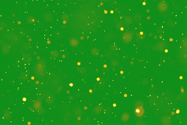 A background featuring golden particles scattered over green, evoking a sense of magic.