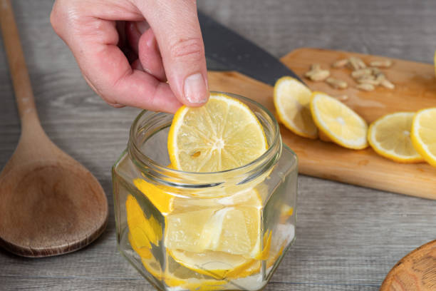 istock woman's hands canning lemon. pour sugar into  jar of lemon. 2205923706
