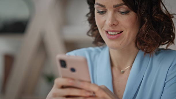 istock Smiling businesswoman reading phone message in modern workspace closeup. 2205923738