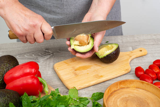 istock cook woman hands preparing avocado for serving. 2205923809