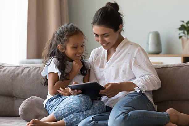 istock Mom and daughter spend leisure at home using digital tablet 2205924329
