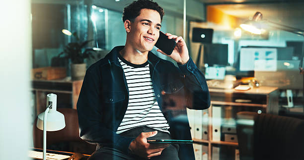 istock Night, phone call and man on tablet for startup report, post deadline or online update research. Thinking, engagement or content strategy with tech for digital marketing trends or social media growth 2205924349
