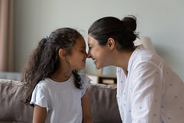 istock Indian mom and little daughter touch noses express love 2205924766