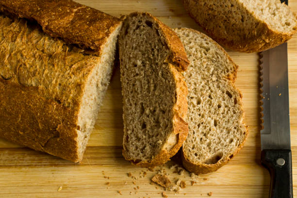 istock Sliced bread on the natural wooden board 2205925013