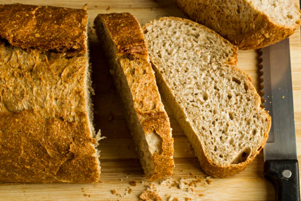istock Sliced bread on the natural wooden board 2205925024