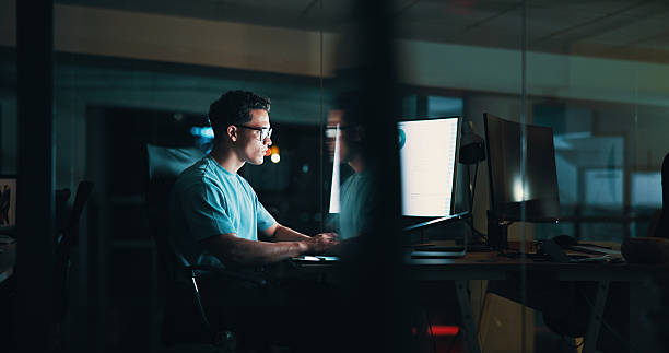 istock Overtime, screen or man on computer for startup report, post deadline or online update research. Engagement, night or content strategist on monitor for digital marketing trends or social media growth 2205925517