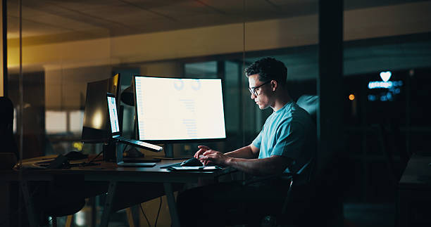 istock Businessman, typing and computer screen with laptop at night for testing application, UI design and code review. Web developer, person and stats chart for industry trends or system update in office 2205925537