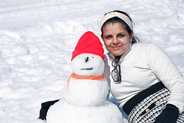 beautiful young lady having fun activity in winter at snow mountain