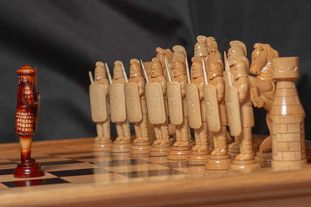 istock Large wooden chess pieces on black background 2205927898